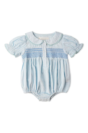 Light blue organic cotton romper featuring a smocked top, round collar, and short puff sleeves. Designed by Makemake Organics, this piece is perfect for warm days and comfortable play.