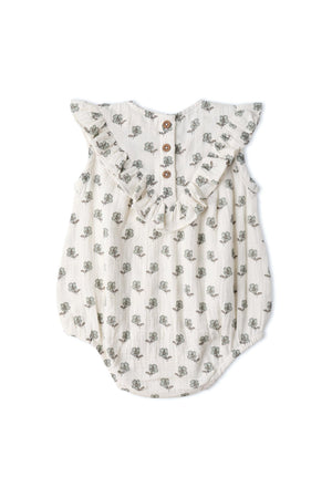 Organic sleeveless bubble romper in cream with delicate floral patterns. Features ruffled sleeves and wooden snap closures, made from soft, breathable fabric for comfort during playtime.