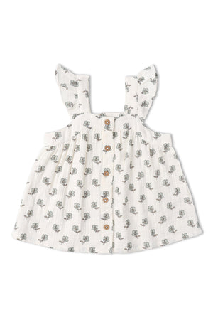 A lightweight, organic cotton flutter top features a delicate floral print and button front. Its airy design is perfect for warm weather, ideal for children’s summer outings and playdates.