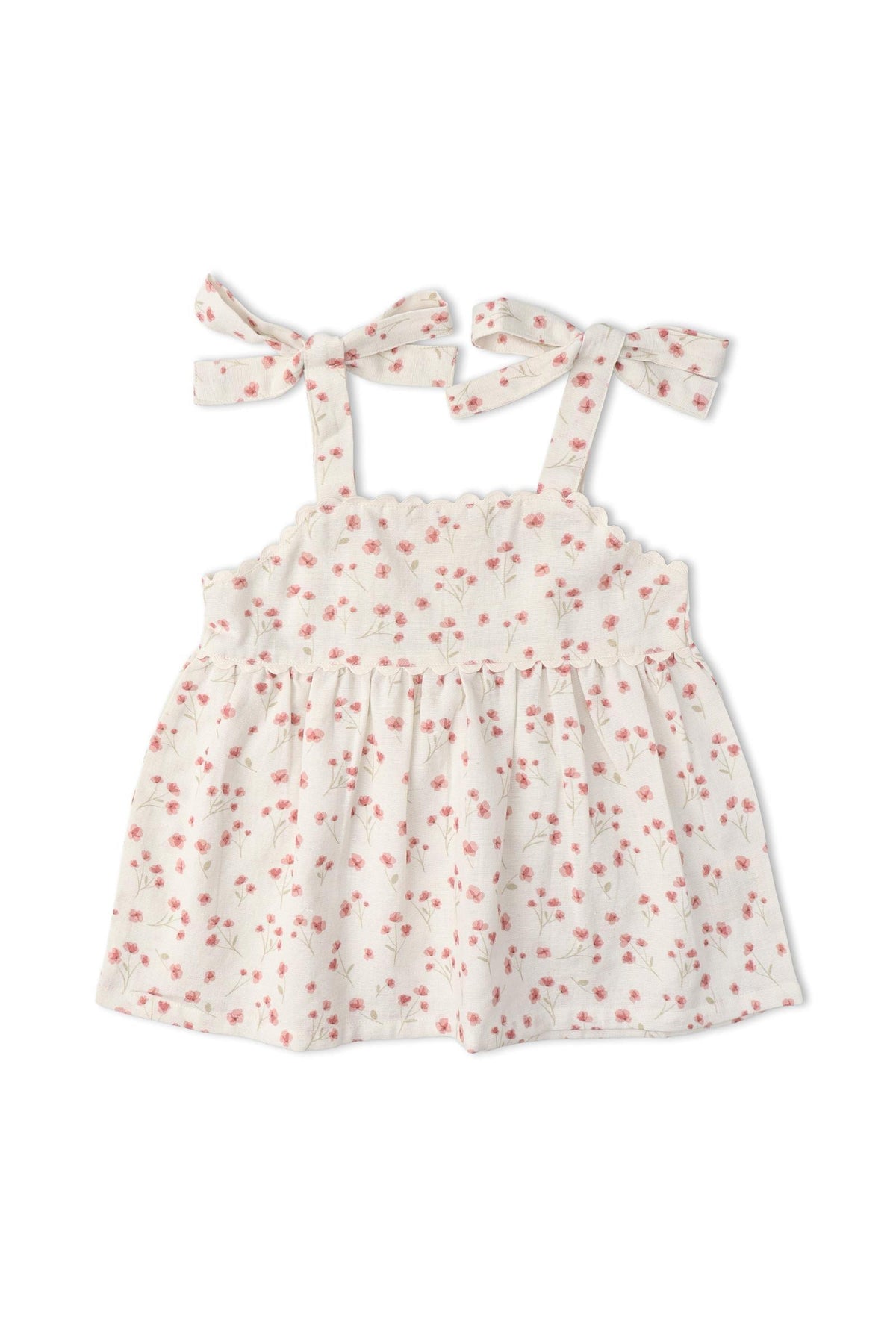 A sleeveless white top with pink floral patterns and adjustable tie straps. Made from soft, breathable fabric, this charming piece is perfect for warm-weather outings and playful adventures.