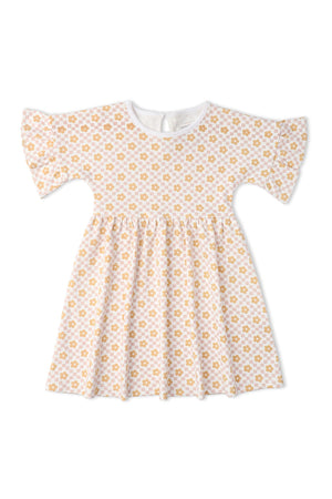 A soft, organic cotton dress featuring a white background with a playful yellow floral print. The dress has dolman sleeves and a relaxed fit, perfect for everyday wear.