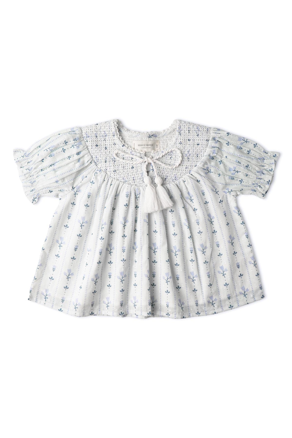 Light blue organic cotton top featuring delicate floral patterns and a smocked neckline with a tassel tie. The short sleeves add a breezy touch, perfect for warm days.
