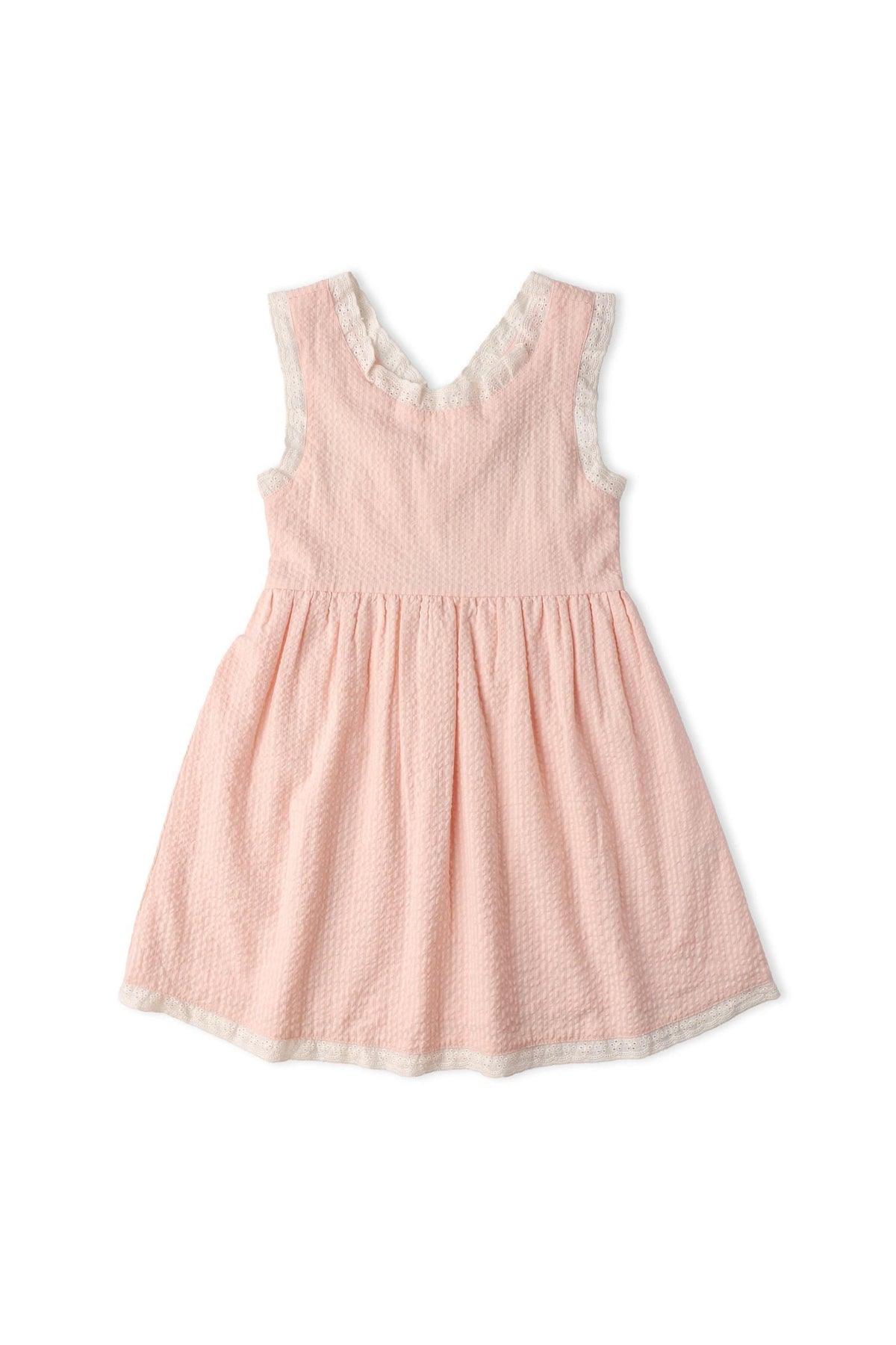 Light pink organic cotton dress featuring criss-cross straps and a gathered skirt. This charming design is perfect for warm weather, ideal for little ones who love to twirl.