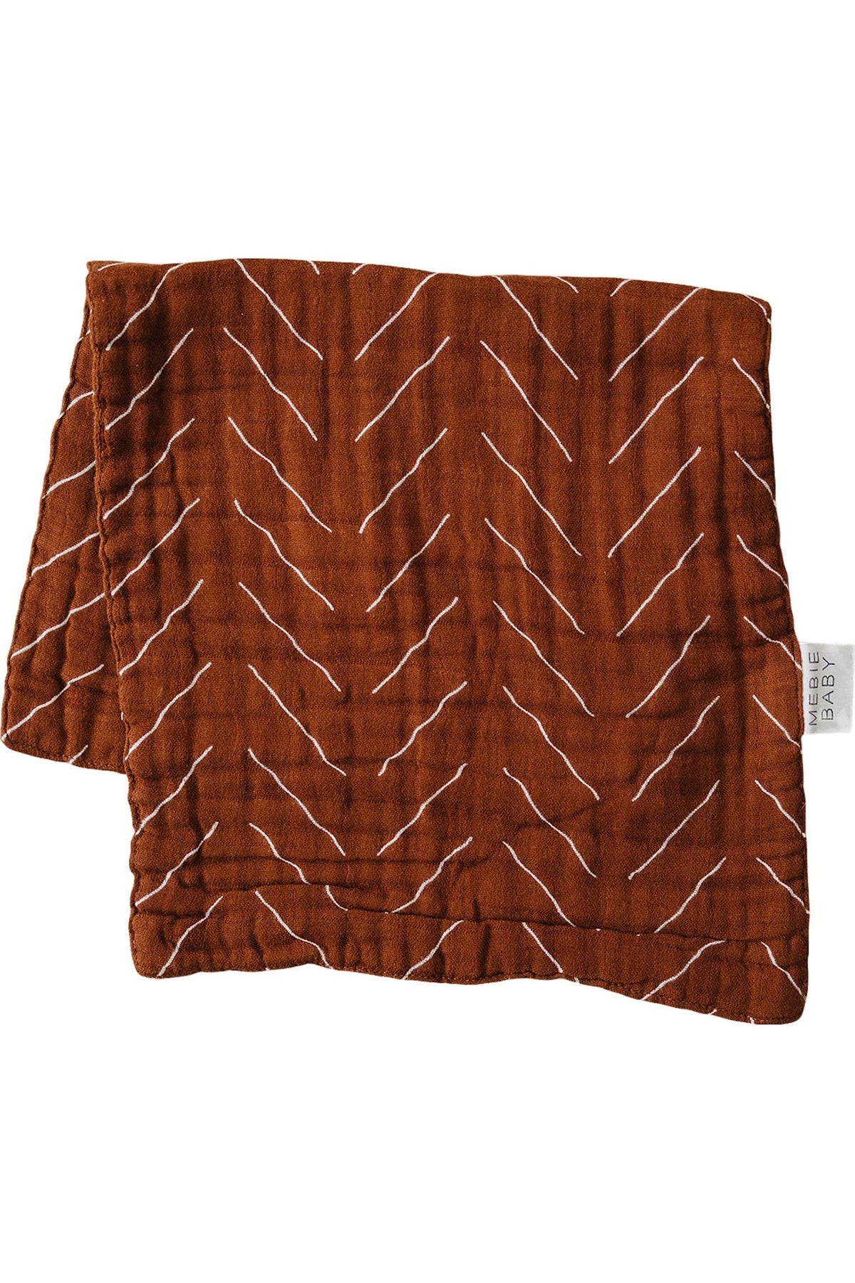 Rust-colored burp cloth with white zigzag pattern, made of soft cotton fabric. Features Mebie Baby branding tag.