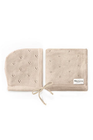 Beige organic cotton pointelle swaddle blanket and hat set with delicate patterns, labeled Bleu La La Organics.