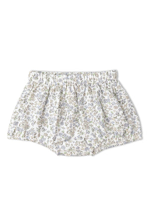 Floral bloomers in soft white fabric adorned with delicate lavender and green flowers. The relaxed fit and gathered waistband offer comfort, perfect for warm-weather play. Ideal for children’s casual outfits.