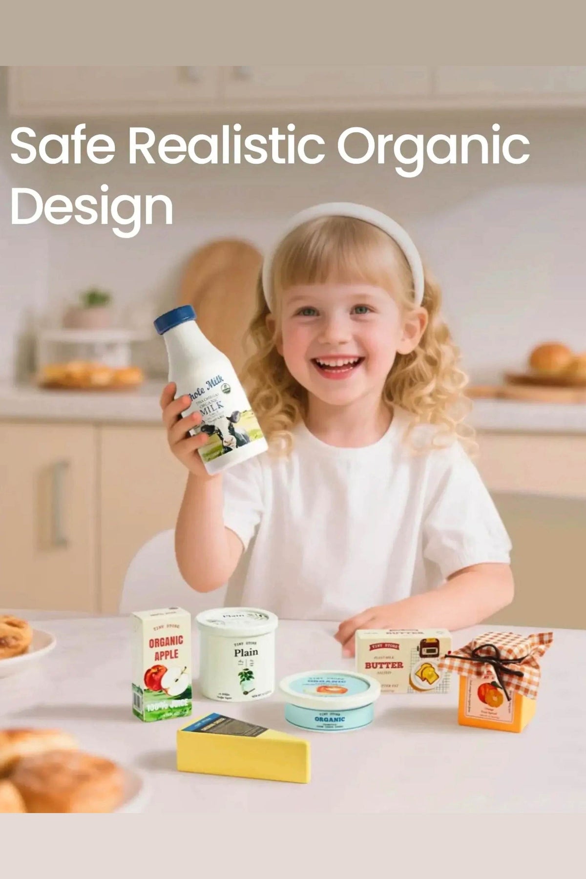 A smiling child holds a milk bottle while surrounded by various wooden dairy play food items, including yogurt and butter, on a kitchen table.