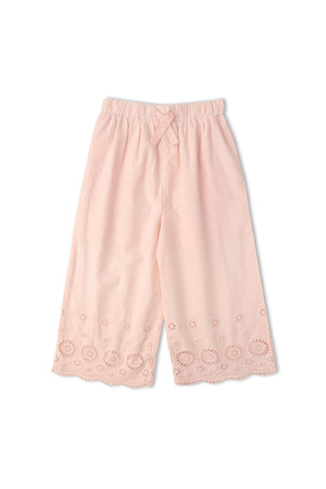 Light pink organic cotton pants featuring delicate eyelet detailing along the hem. These breezy, sustainable bottoms are perfect for warm-weather outings and designed for comfort and style.