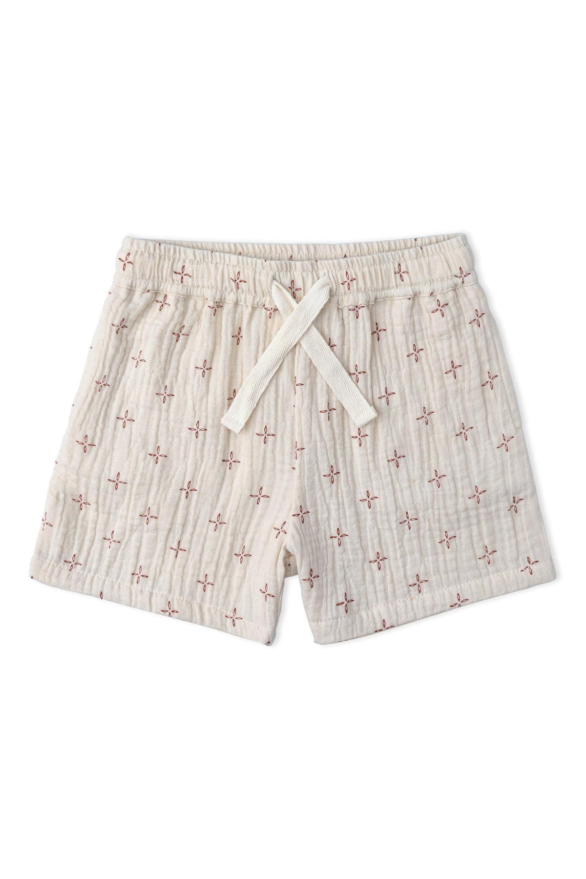 Lightweight organic cotton shorts in a cream color, featuring a subtle floral pattern and an adjustable drawstring waist. Ideal for comfortable summer wear, perfect for children’s adventures.