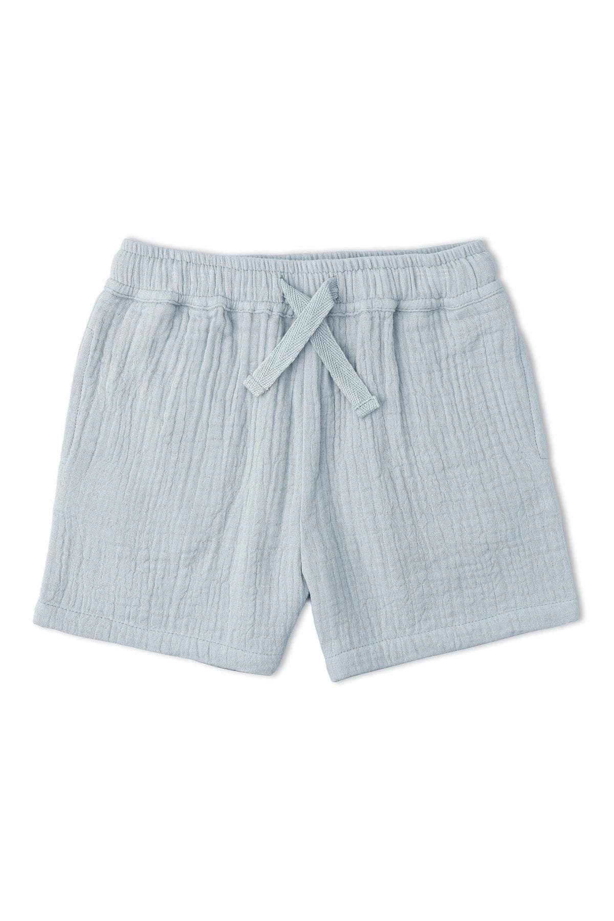 Light blue organic cotton shorts featuring a textured, crinkled fabric and an elastic waistband with a drawstring. Ideal for keeping kids comfortable during warm summer days.