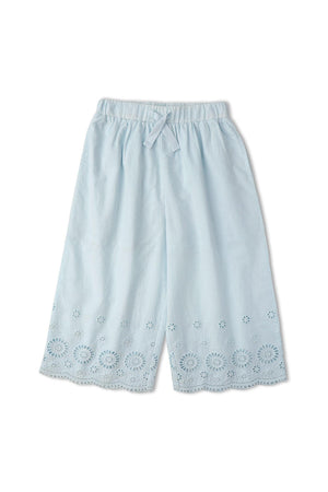 Light blue organic cotton pants featuring intricate eyelet cutwork along the hem. Designed for comfort and style, these breezy culottes are perfect for warm-weather outings.
