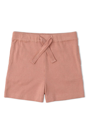 Soft, coral pink organic cotton shorts featuring a comfortable elastic waistband and tie detail. Ideal for playtime, these shorts are part of a sustainable kids clothing collection by Alterra Retail.