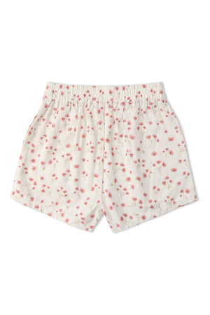 White shorts featuring a delicate pink floral pattern, made from soft organic cotton. The design includes an elastic waistband, ideal for comfort during warm-weather play.