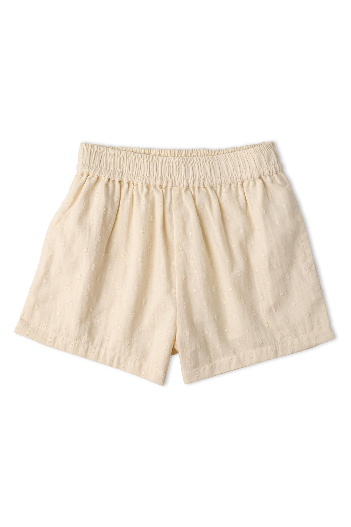 Light beige organic cotton shorts with an elastic waistband. The fabric features a subtle textured pattern, perfect for comfortable, sunny day outings. Ideal for children’s casual wear.