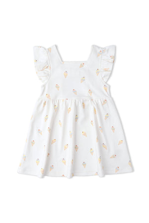 A playful cutout back dress features a white fabric adorned with colorful ice cream cone prints. This organic cotton dress has ruffled sleeves, perfect for warm weather outings.