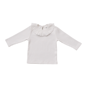 A soft, white ribbed cotton top with long sleeves and a ruffled collar, designed for toddlers and kids. Ideal for layering or wearing alone in various settings.