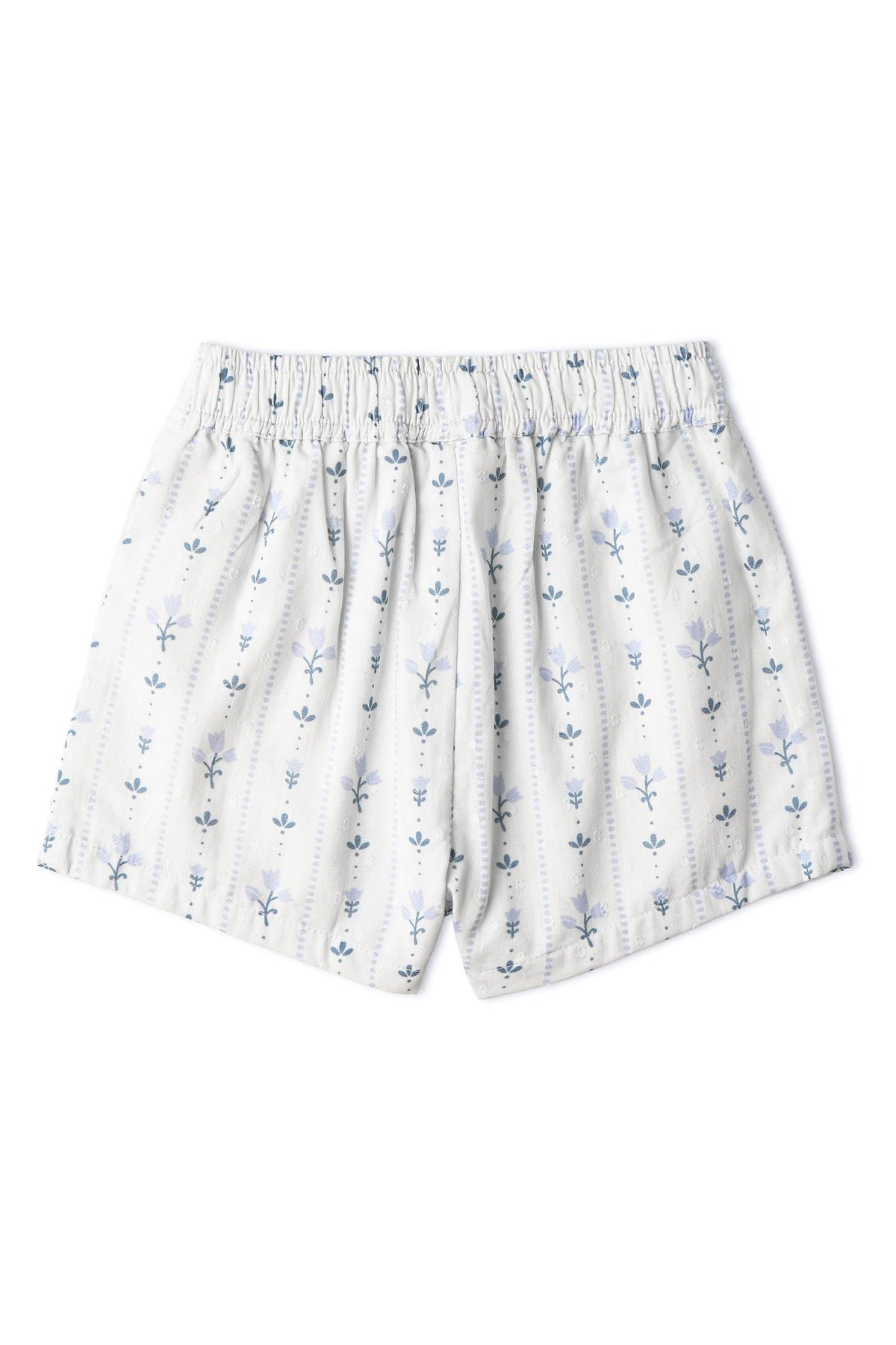 Light blue shorts with a smocked waistband feature a delicate floral pattern. Made from organic cotton, these playful shorts are designed for comfort and sunny day outings.