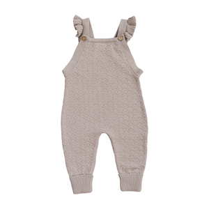 Classic taupe knit overalls for baby girls, featuring delicate ruffle straps and wooden buttons. Made from soft, breathable cotton, these stylish overalls are perfect for everyday wear or special occasions.
