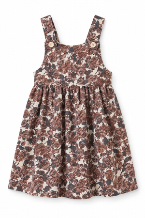 Flora corduroy cotton dress featuring a floral print in warm browns and creams. The sleeveless design includes wooden button accents, perfect for toddlers and kids in cooler weather.