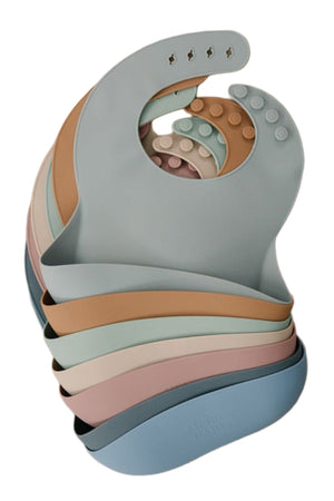 Stack of Mebie Baby silicone bibs in pastel colors with adjustable button closures, BPA free design.