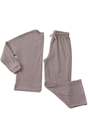 A soft, breathable cotton loungewear set featuring a long-sleeve top and drawstring pants in a muted striped pattern, perfect for relaxing at home or family gatherings.