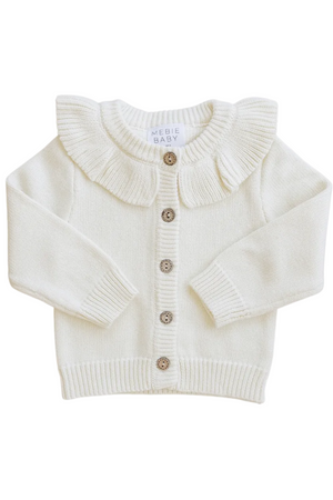 Cream ruffle knit cardigan featuring a delicate ruffle collar and wooden buttons. This cozy piece from Mebie Baby is perfect for layering in your little ones wardrobe.