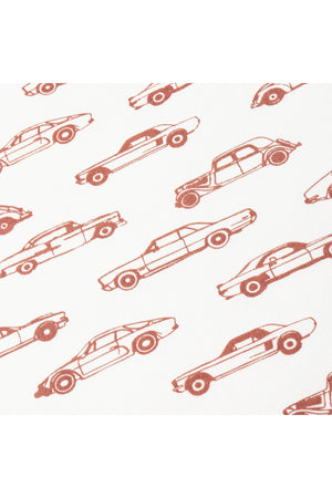 A close-up of fabric featuring a playful cars print in earthy tones on a white background. This organic cotton material is ideal for childrens clothing, promoting comfort and sustainability.