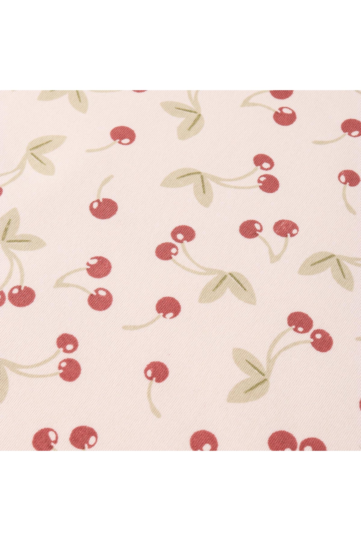 A light fabric featuring a playful cherry print, with red cherries and green leaves on a soft background. This design is perfect for a lightweight, organic cotton dress.