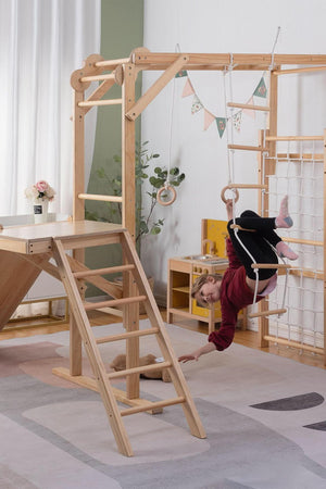 A child swings from a rope on a wooden jungle gym playset, featuring a natural wood finish and a climbing ladder.