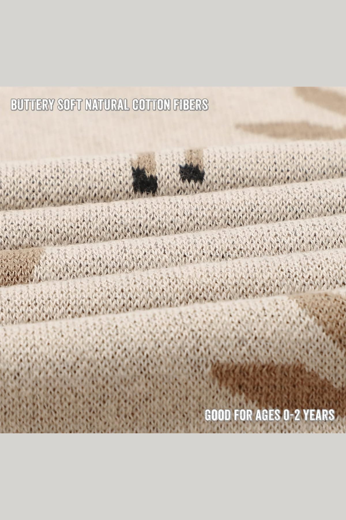 Close-up of a beige knit fabric with subtle deer patterns, made from soft natural cotton fibers.