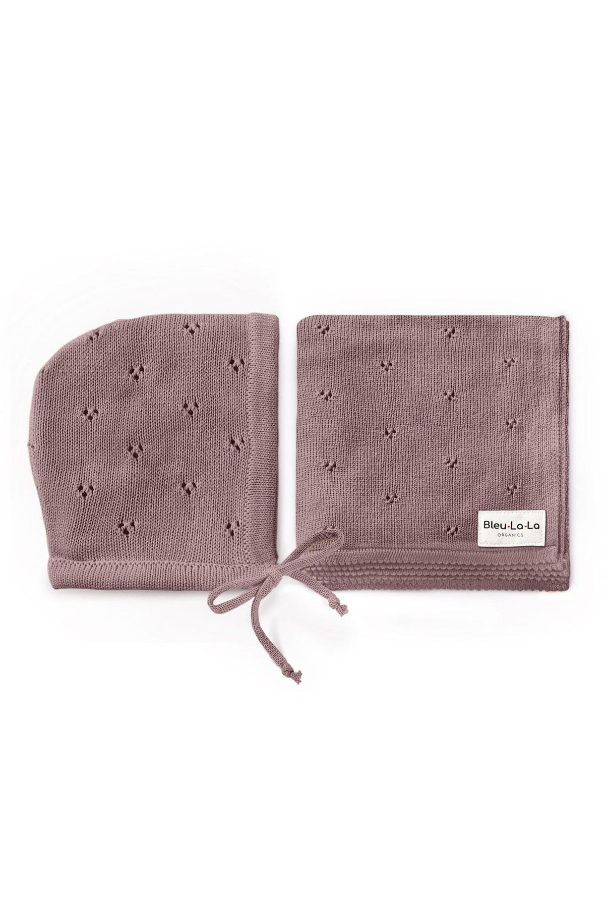 A mauve pointelle swaddle blanket and hat set made from organic cotton, featuring delicate patterns and a tie detail.