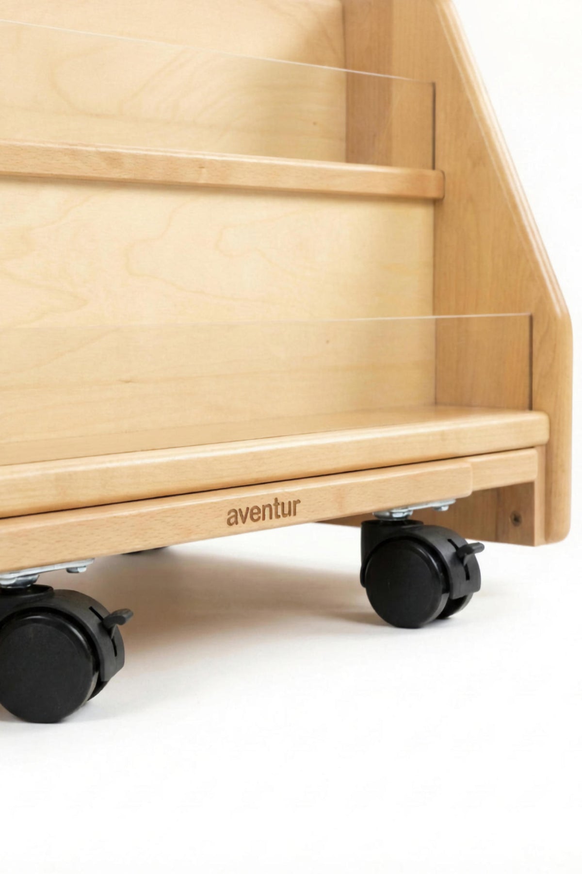 Close-up of a wooden bookshelf by Avenlur, featuring smooth surfaces and flip-up wheels for mobility. The natural wood finish highlights its eco-friendly design, perfect for childrens spaces.