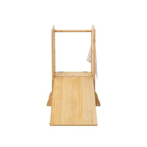 A wooden, foldable kitchen tower features a sloped slide and a sturdy frame. Its natural finish highlights sustainable materials, designed for toddlers play and learning experiences.
