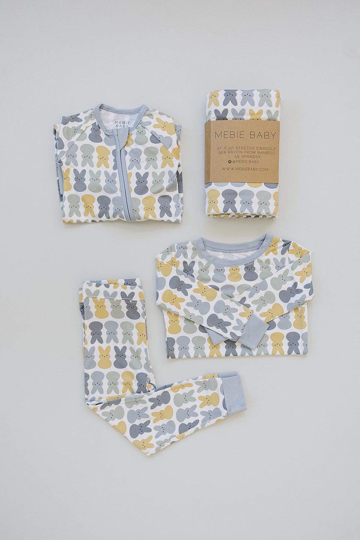 Mebie Baby bamboo pajamas and swaddle in pastel bunny print, featuring blue, yellow, and gray colors on display.