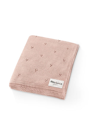 Pink knit swaddle blanket with small perforations, featuring a Bleu La La Organics label. Made from organic cotton.