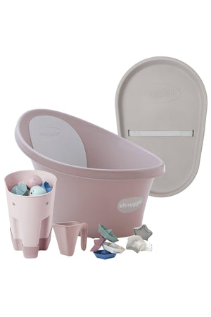 Pink Shnuggle baby bath set with accessories including toys and a changing mat, designed for newborn care.