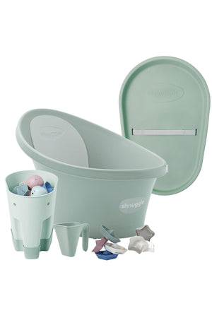 Mint green Shnuggle bath set with tub, changing mat, jug, and colorful toys for newborns.