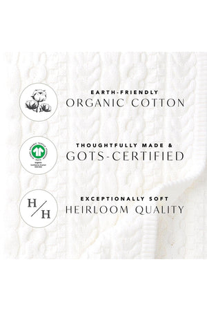 White textured fabric featuring organic cotton labels, highlighting GOTS certification and heirloom quality. Ideal for sustainable clothing choices.