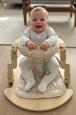 A happy baby sits in a light wooden activity seat with a soft, padded cushion. The seat features natural materials and is designed for safe and enjoyable playtime.