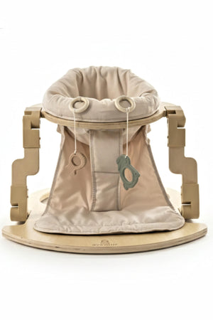 A premium foldable wooden baby activity seat featuring a soft beige fabric insert with hanging toys. The sturdy wooden base offers stability, making it ideal for safe, engaging playtime.