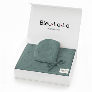 A beautifully packaged gift set from Bleu La La, featuring a soft, organic cotton pointelle blanket and a coordinating newborn hat in a calming teal color.