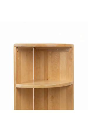 Natural wooden corner bookshelf featuring a smooth finish and minimalist design, ideal for organizing books and learning materials in a childs space. Perfect for fostering independent learning.