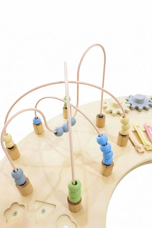 A wooden activity table features colorful beads on curved wires, encouraging sensory play and fine motor skills for young children.