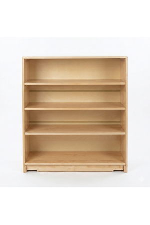 Light, natural wood shelf with four spacious open shelves, ideal for organizing books and toys in a childs room. This Montessori-inspired unit promotes easy access and tidy storage.