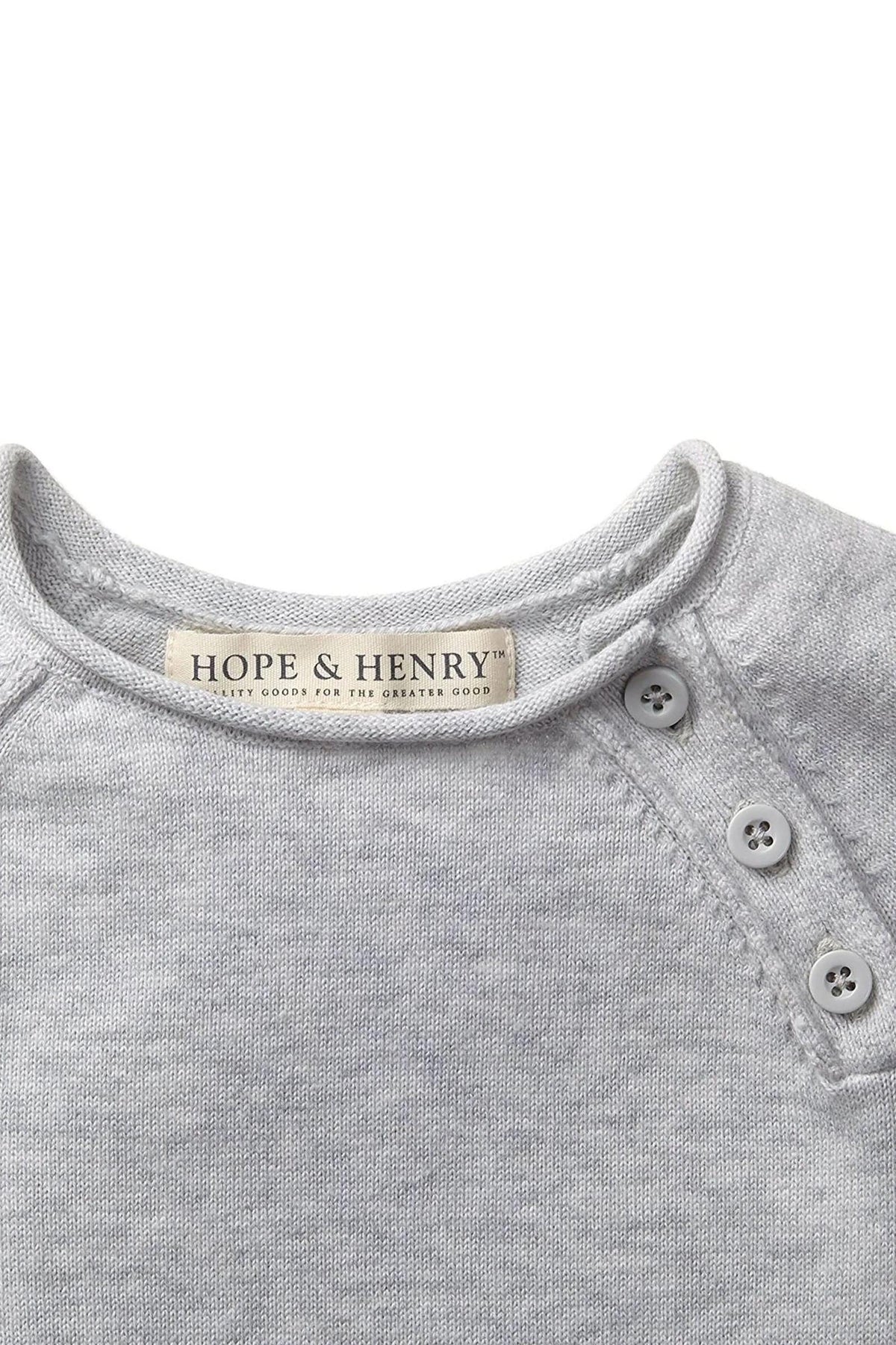 Close-up of a light gray organic cotton romper by Hope & Henry, featuring a round neckline and button details.