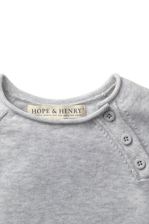 Close-up of a light gray organic cotton romper by Hope & Henry, featuring a round neckline and button details.