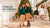 Four children wearing Hope & Henry green sweaters and holiday dresses beside a Christmas tree and garland decorated staircase.