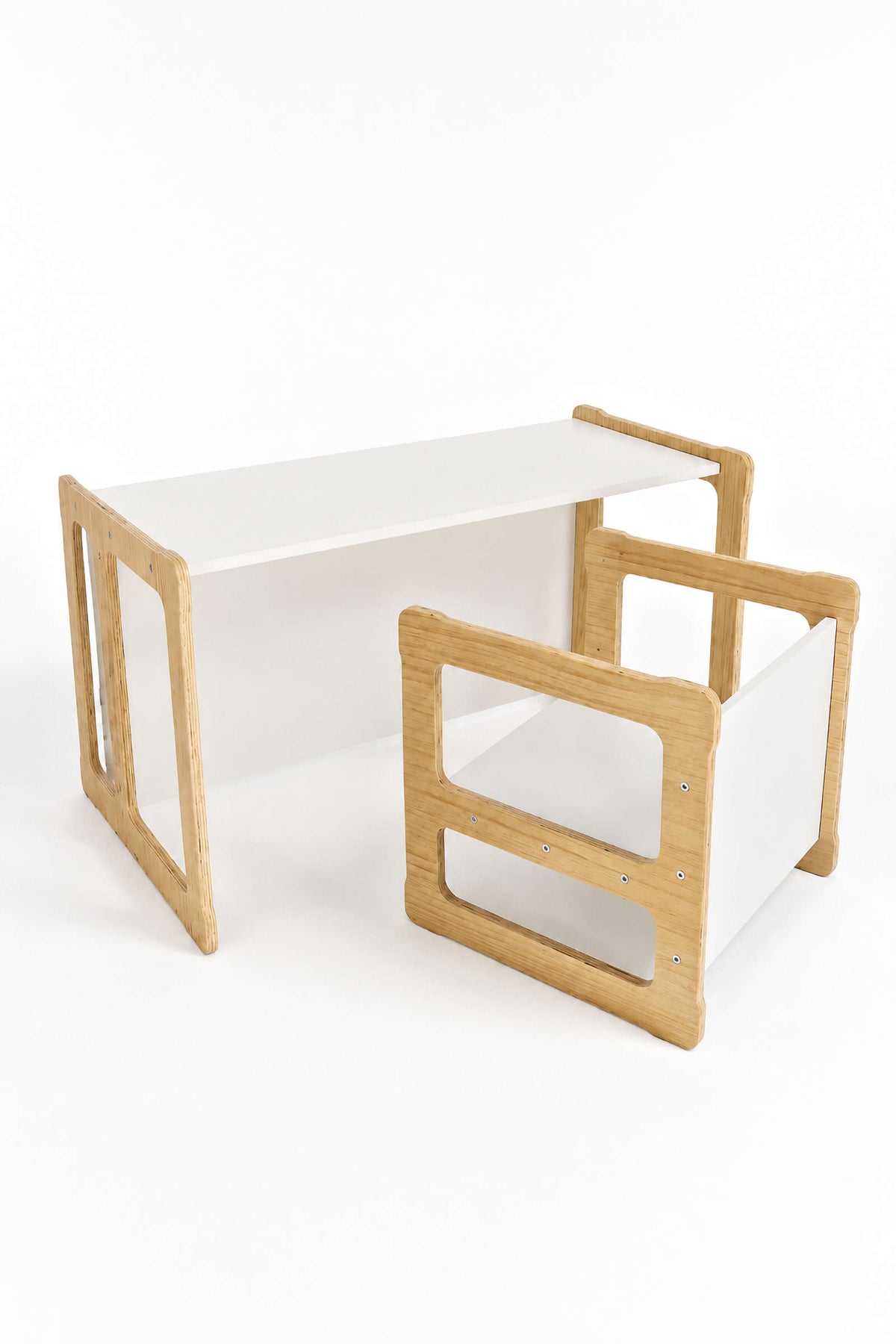 A white wooden table with natural wood accents is shown beside a matching chair. The convertible design is ideal for childrens activities and promotes eco-friendly play and learning.