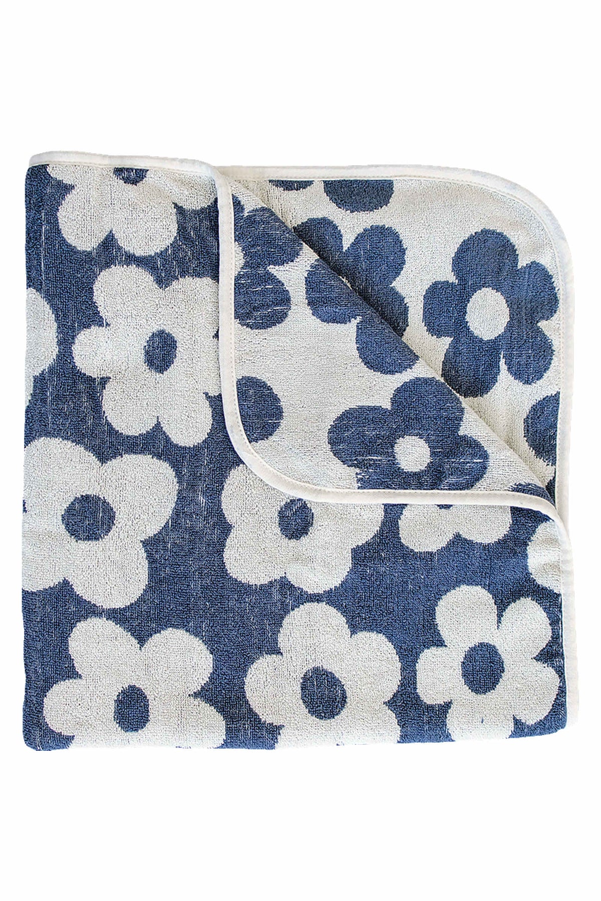 Navy blue floral towel with white flowers, made from organic cotton, folded neatly with rounded corners.