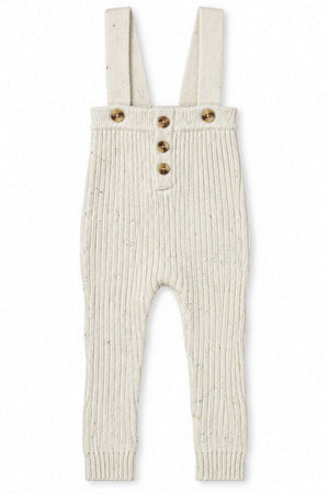 Cream-colored knit cotton overalls feature ribbed texture, adjustable straps, and wooden buttons. Designed for babies and toddlers, these soft and sustainable overalls provide comfort and style for everyday wear.